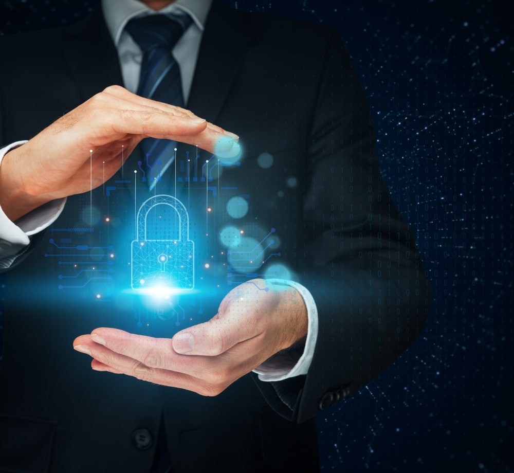 Protecting,Your,Digital,Assets:,A,Businessman’s,Hands,Gently,Cradle,A